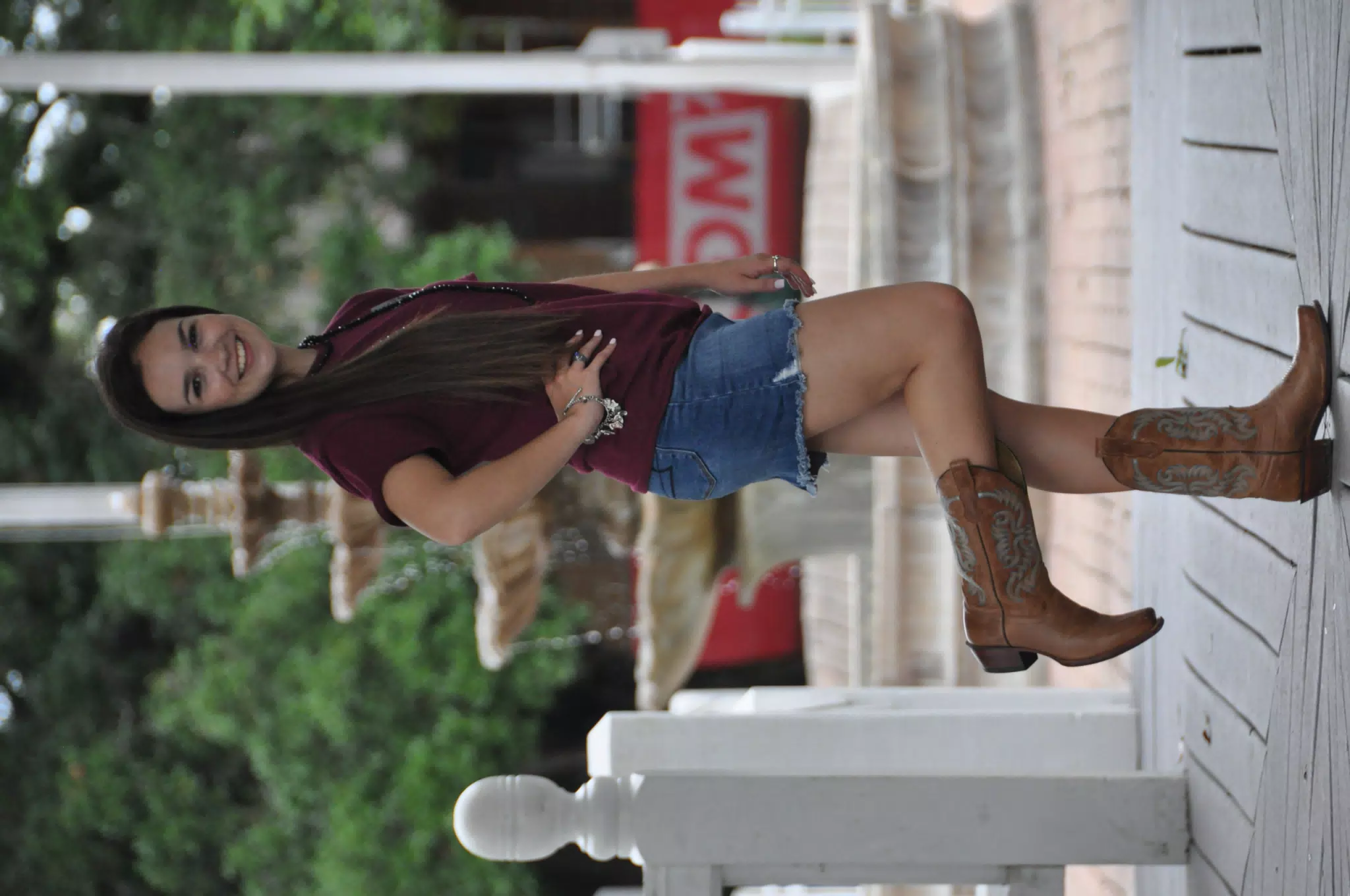 Teen Brunette Modeling Denim Skirt and Cowboy Boots