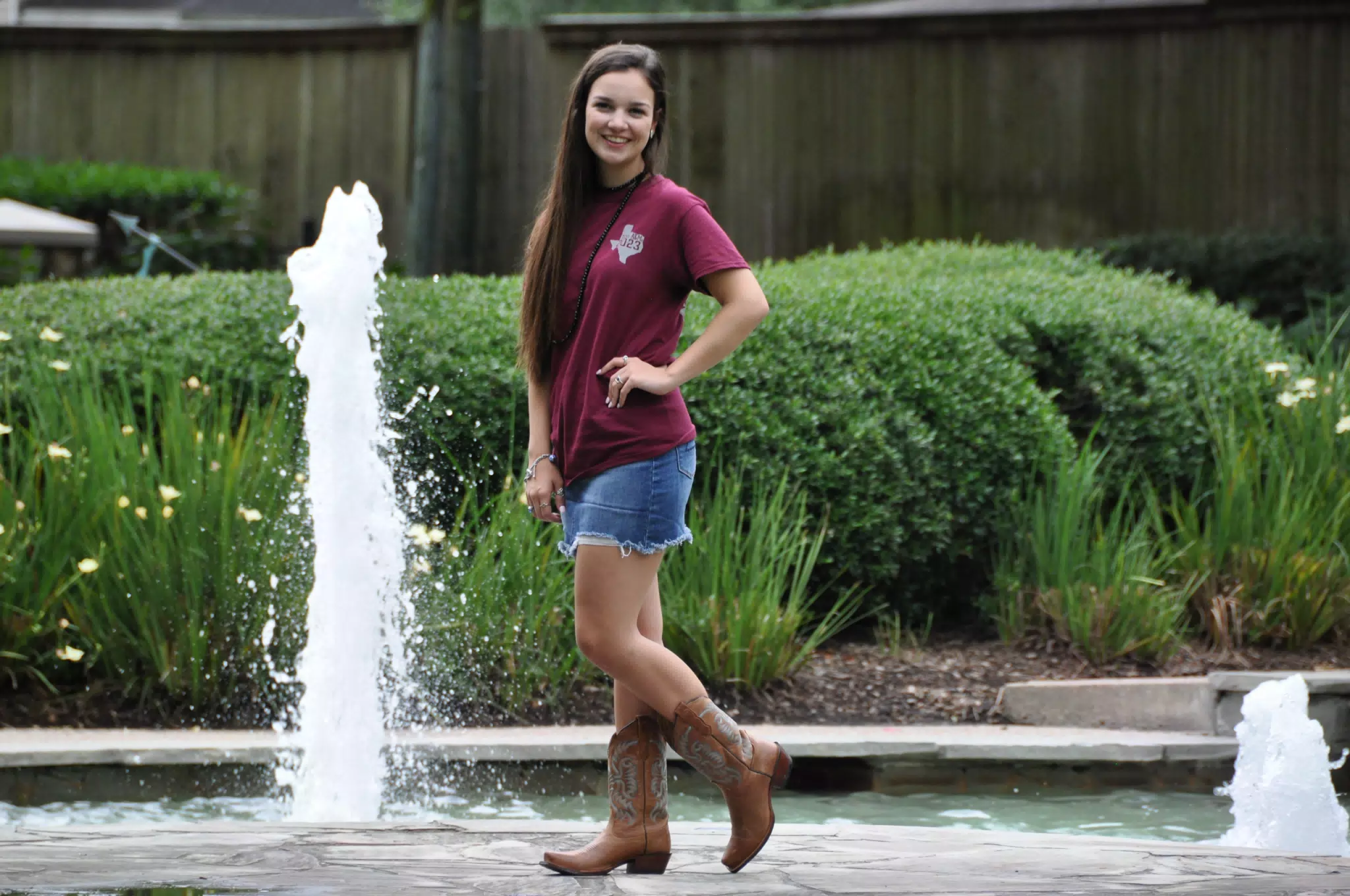 Emily Posing by Fountain in Denim Skirt