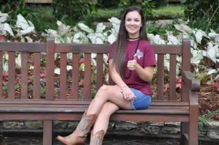 Emily Giving Thumbs Up on Bench in Park