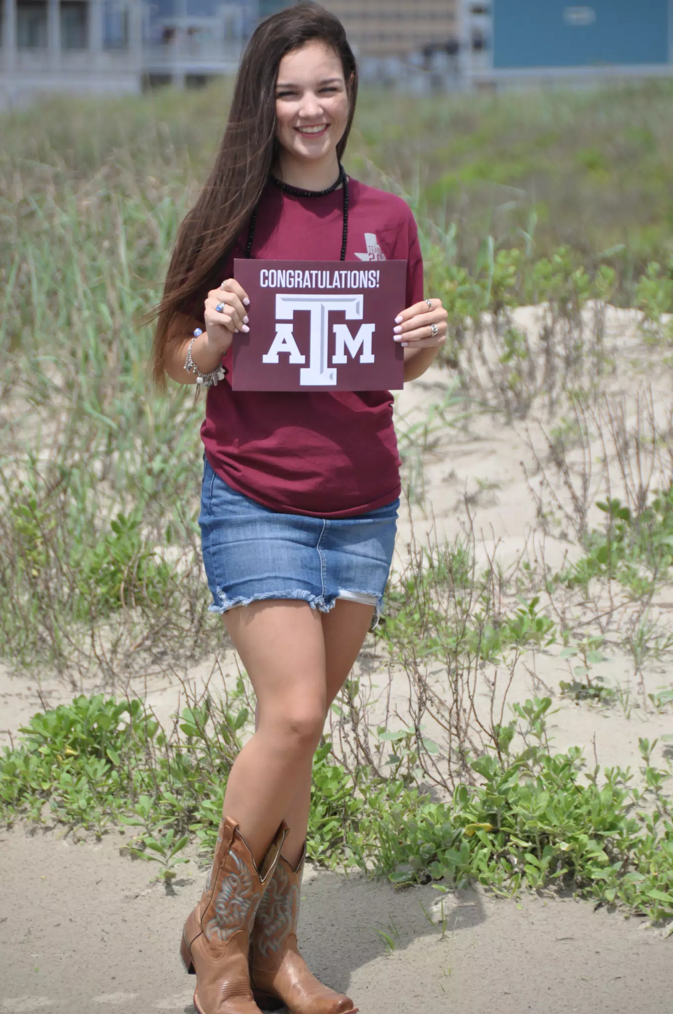 Emily Holding Aggie Sign on Galveston Beach