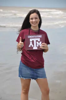 Girl on Beach with Texas A&M Sign