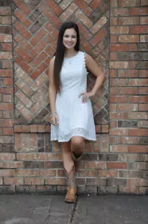 Teen Model in White Dress by Brick Wall