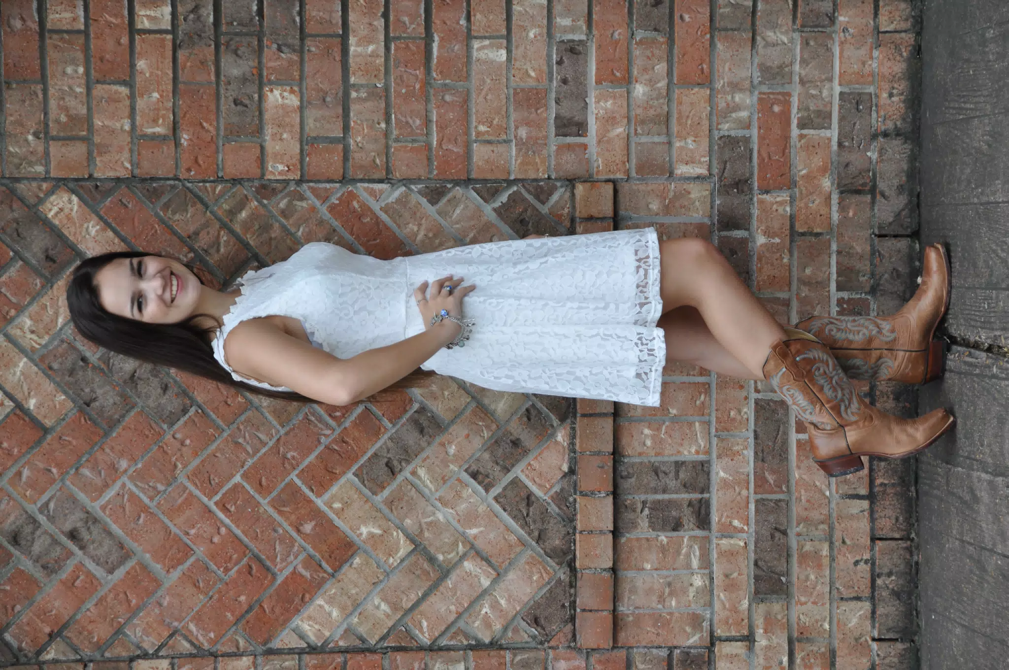 Emily Modeling White Dress & Cowgirl Boots by Brick Wall in Texas