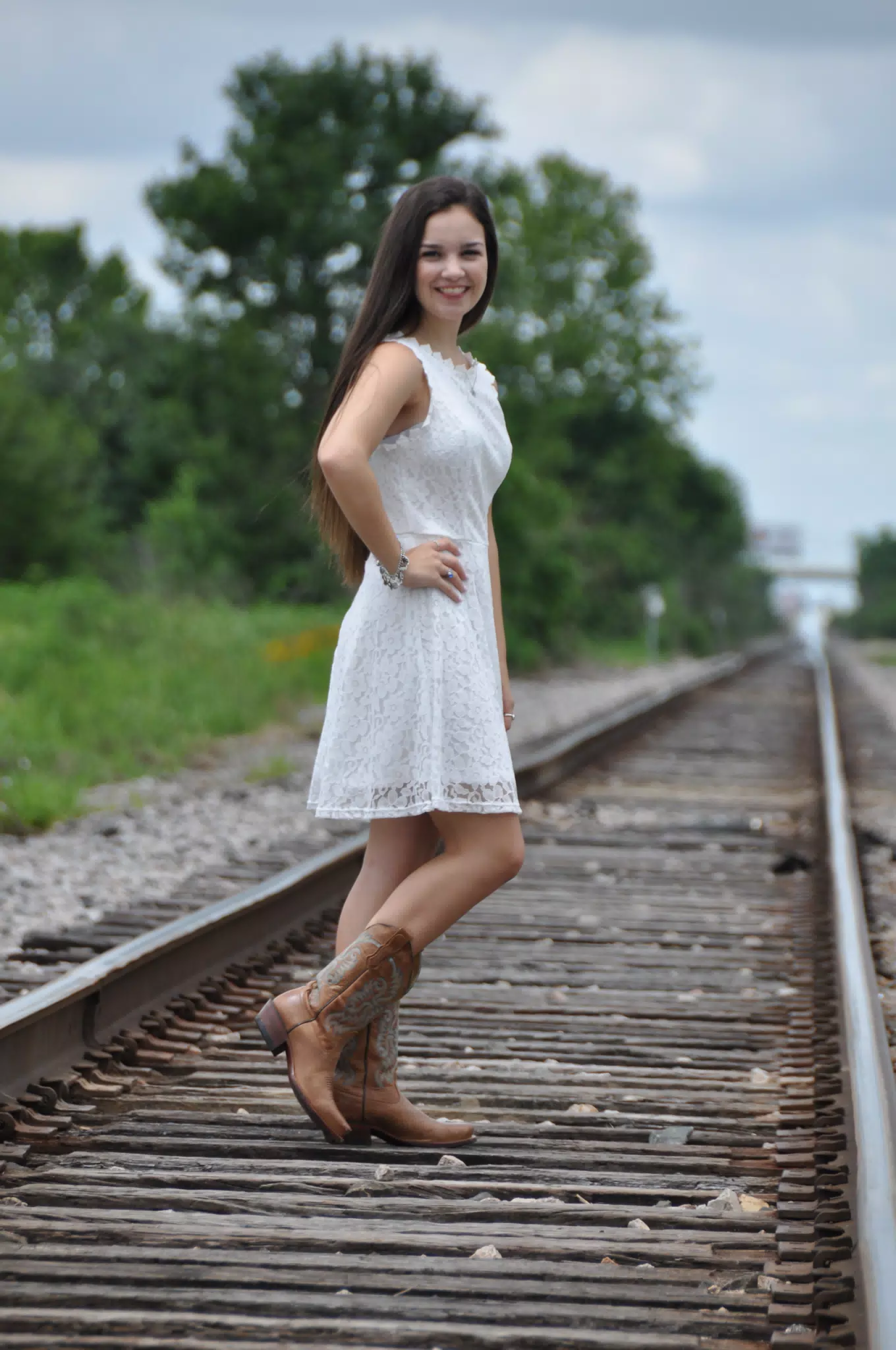 Emily in White Dress and Boots on Tracks