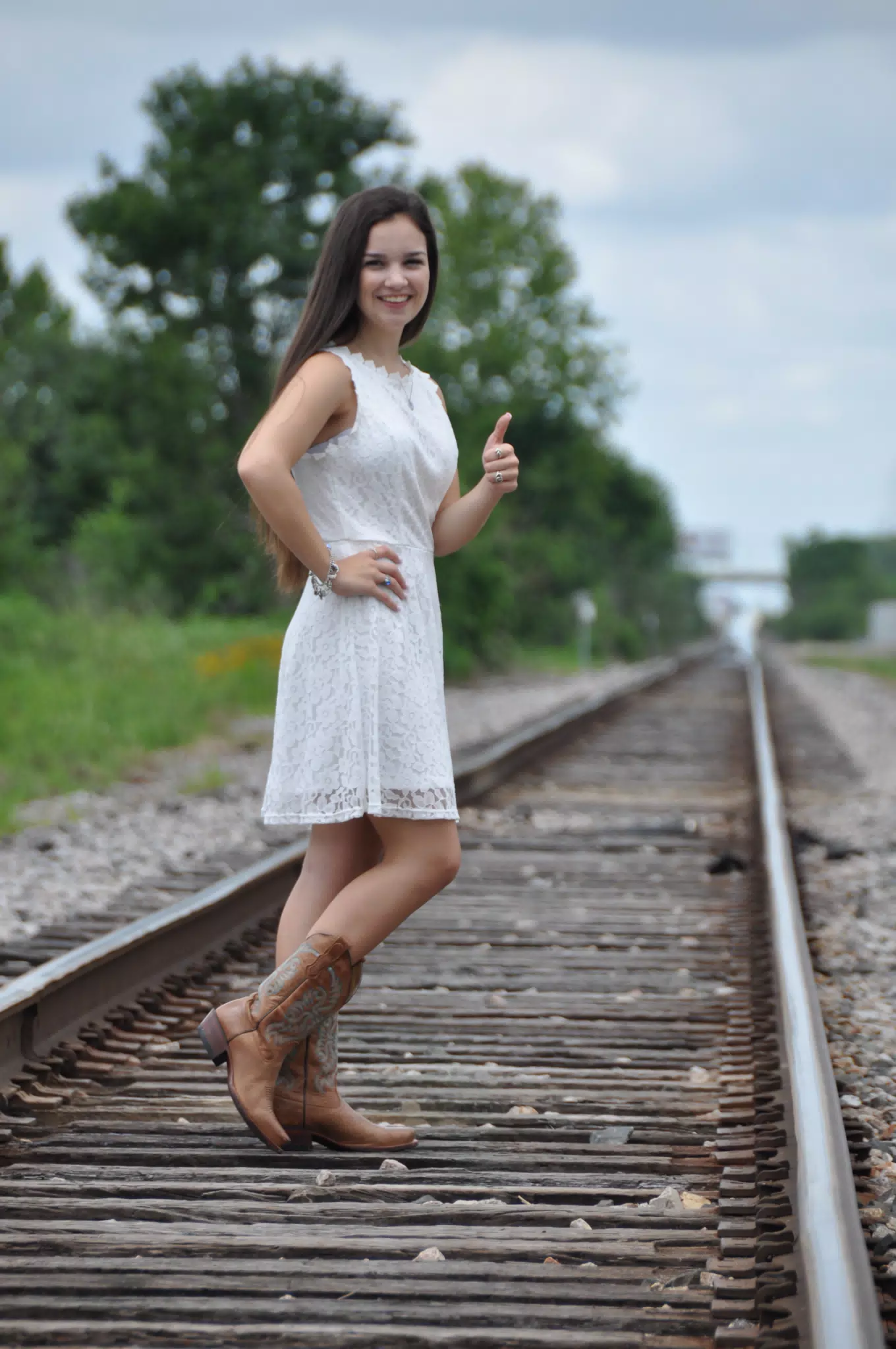 Emily in White Dress on Railroad Tracks