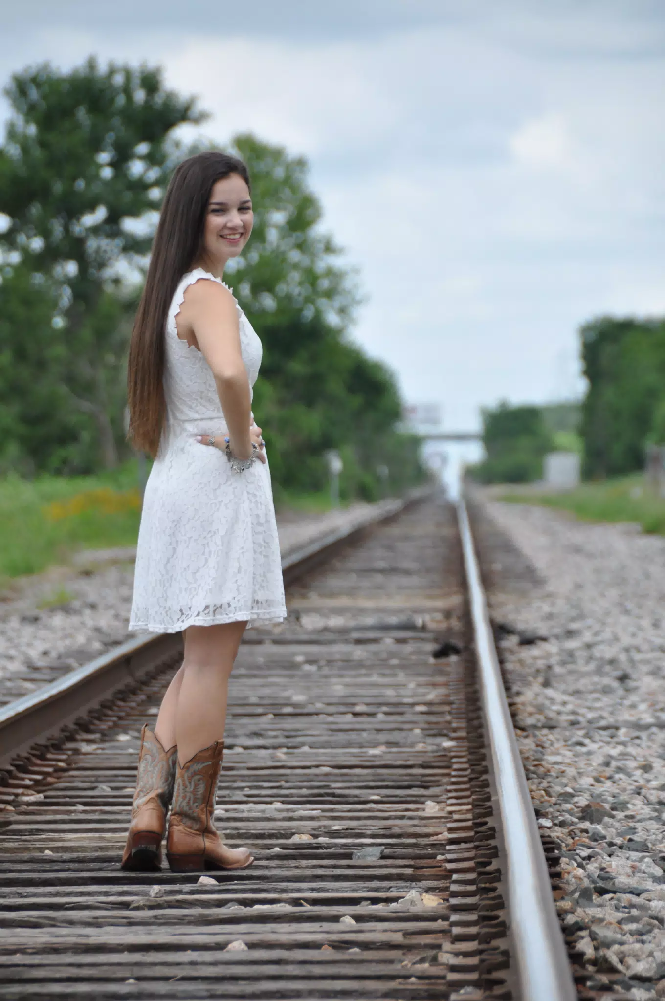 Girl in White Dress on Railroad Tracks in Cowgirl Boots in Texas