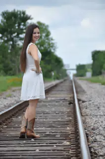 Girl in White Dress on Railroad Tracks in Cowgirl Boots in Texas