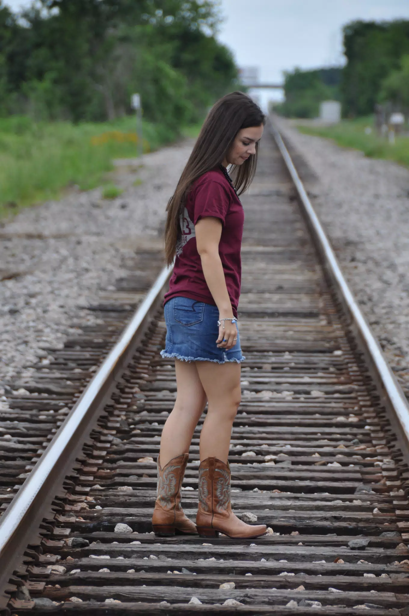 Teen Model Walking Down Railroad Tracks in Texas