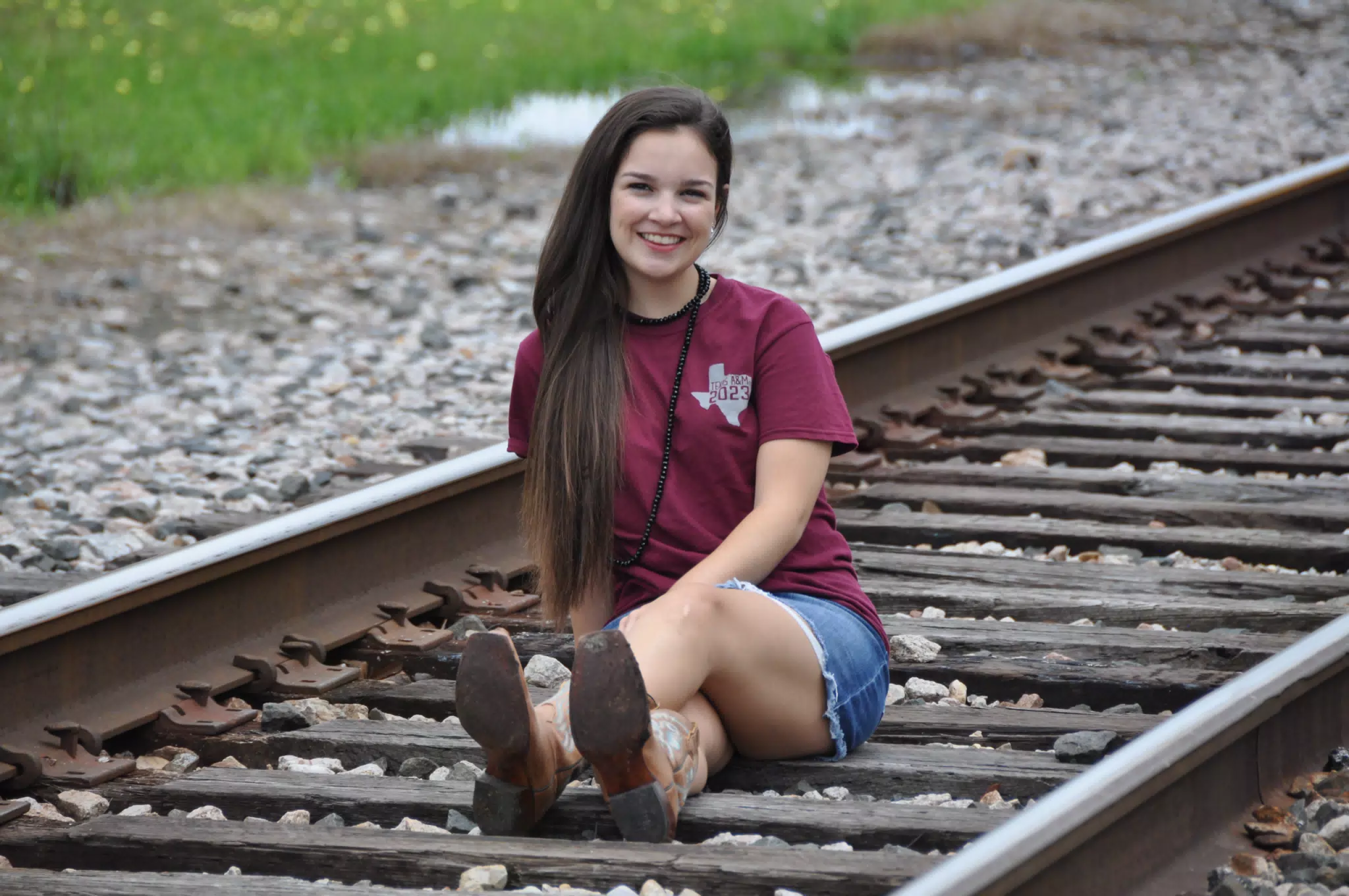 Teen Brunette Model Emily on Railroad Tracks in Texas in Jean Miniskirt & Cowgirl Boots