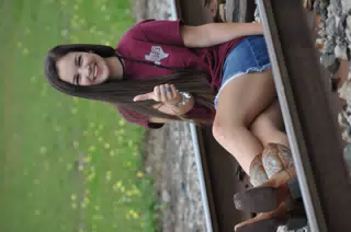 Emily Thumbs Up on Railroad Tracks