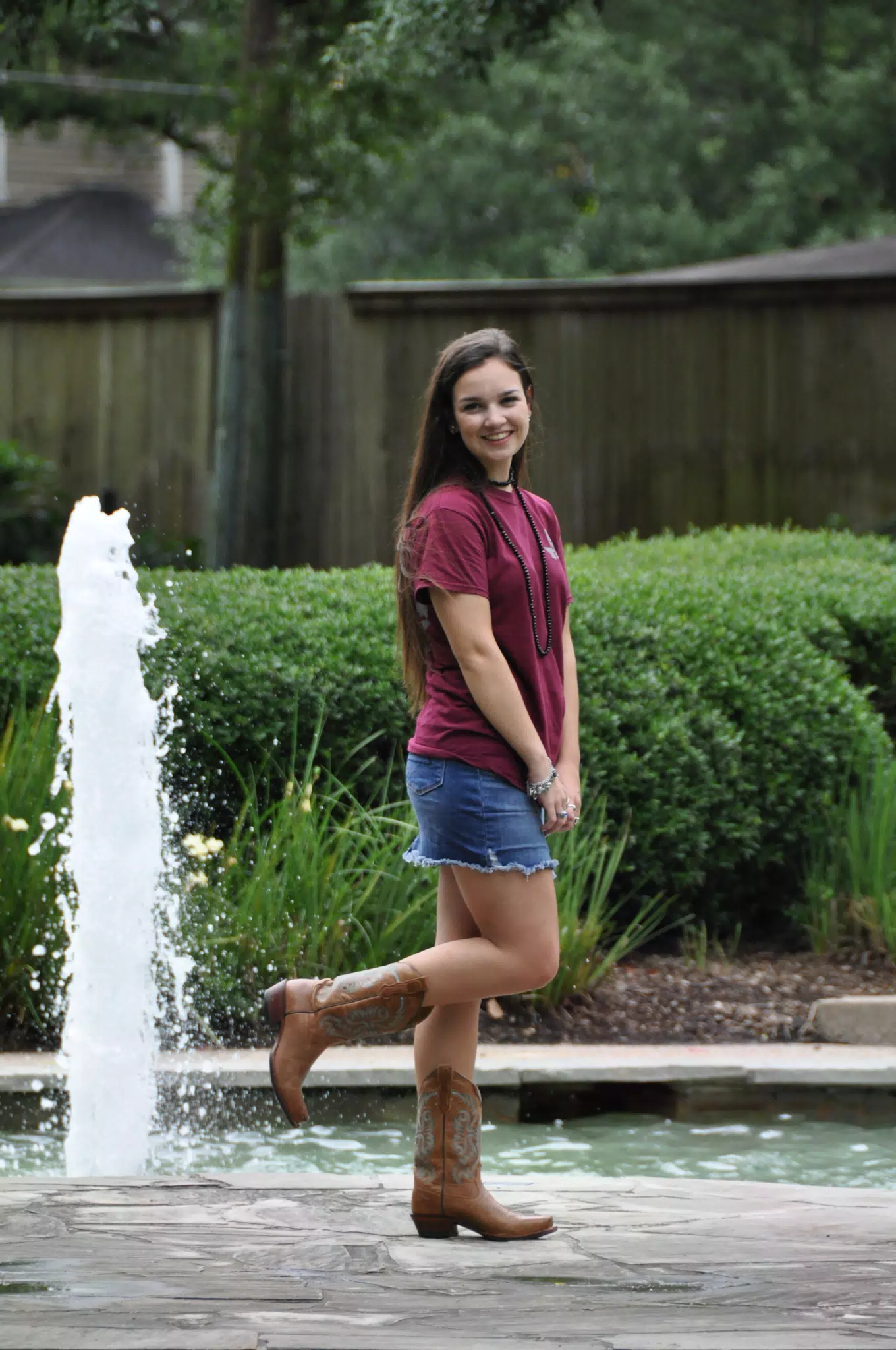 Teen in Jean Miniskirt and Boots by Fountain