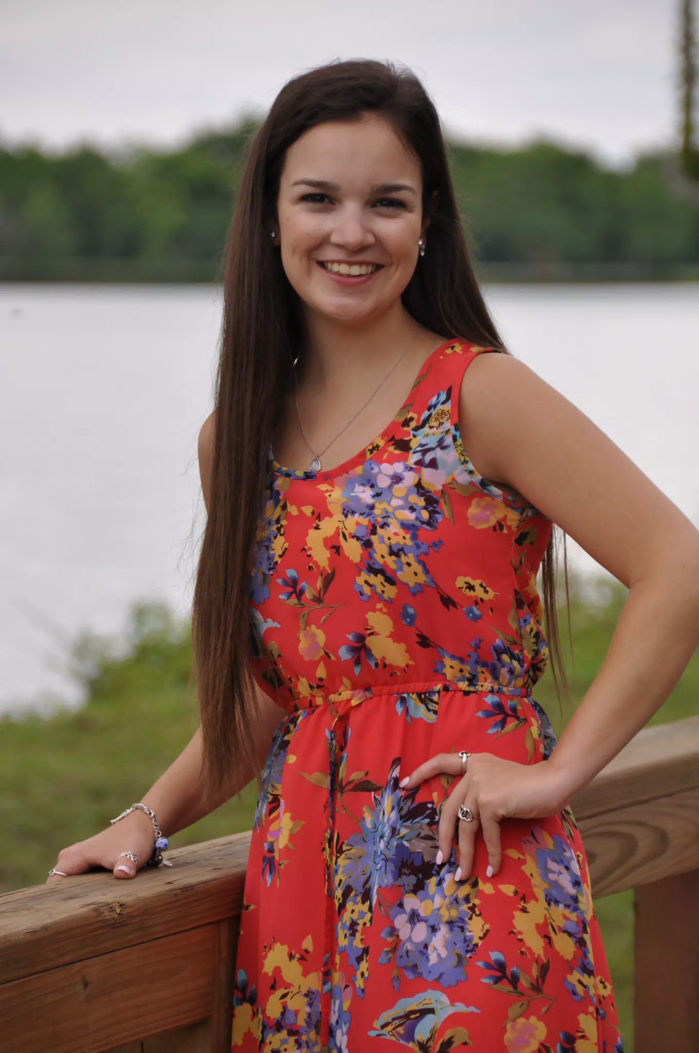 Emily Posing in Red Dress by Railing by Pond