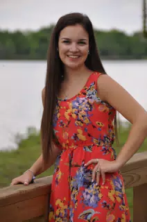 Emily Posing in Red Dress by Railing by Pond