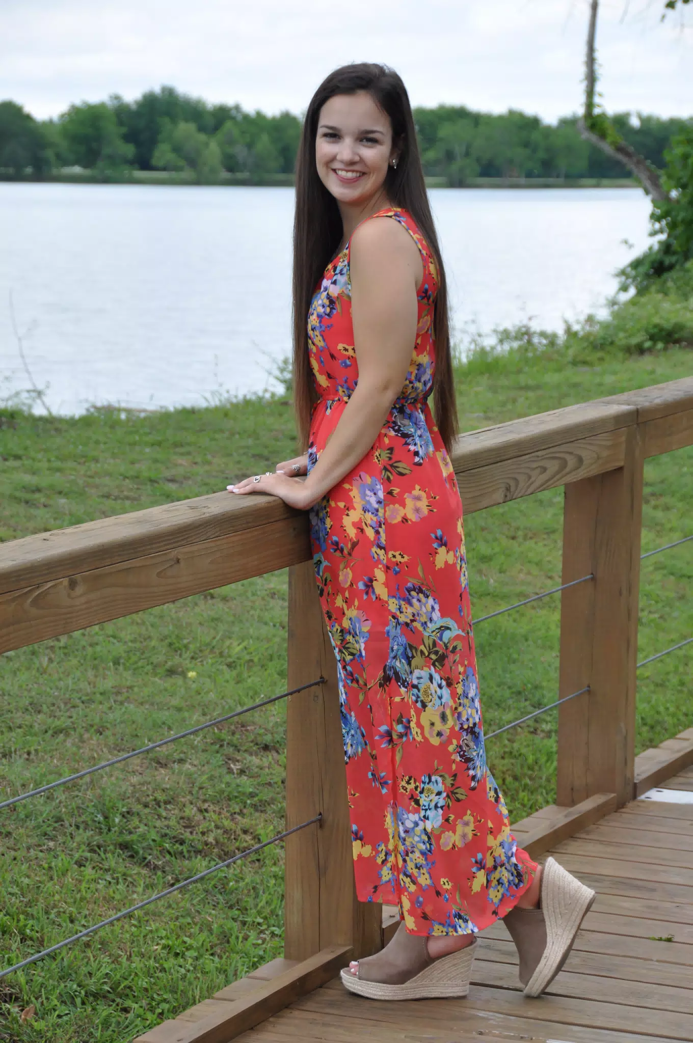 Brunette Modeling Red Dress on Boardwalk in Texas