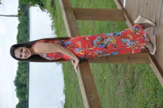 Brunette Modeling Red Dress on Boardwalk in Texas