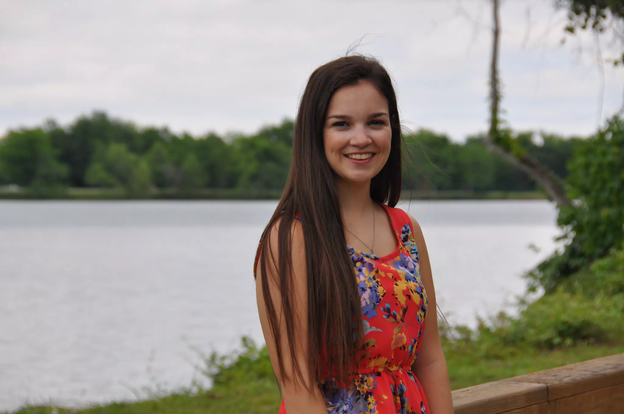 Brunette Teen Model with Long Hair in Red Dress by Lake