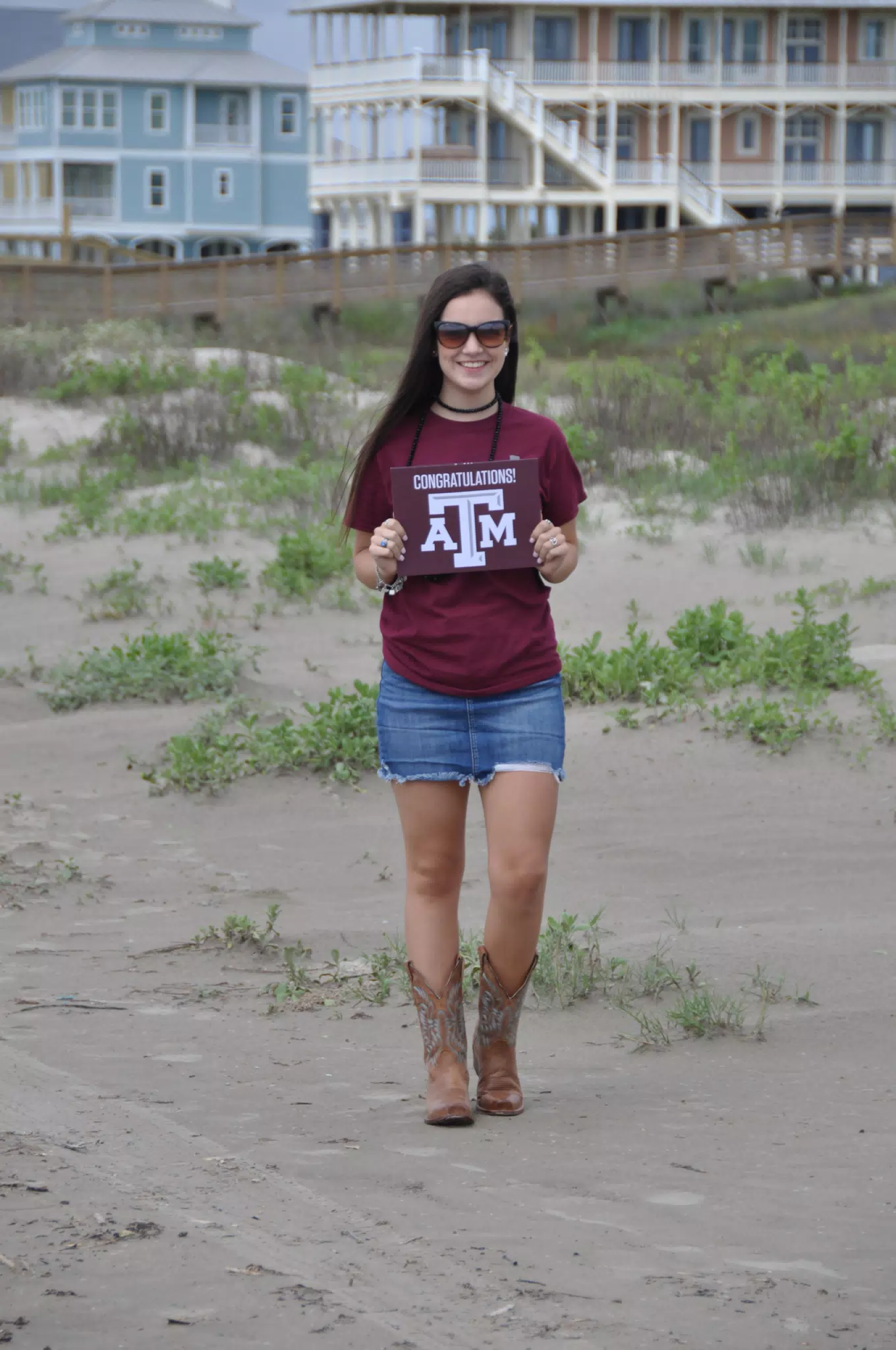 Emily on Galveston Beach in Cowgirl Boots Holding TA&M Sign
