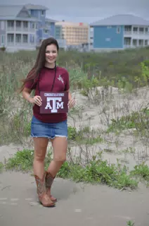 Emily on Galveston Beach in Skirt with Aggie Sign