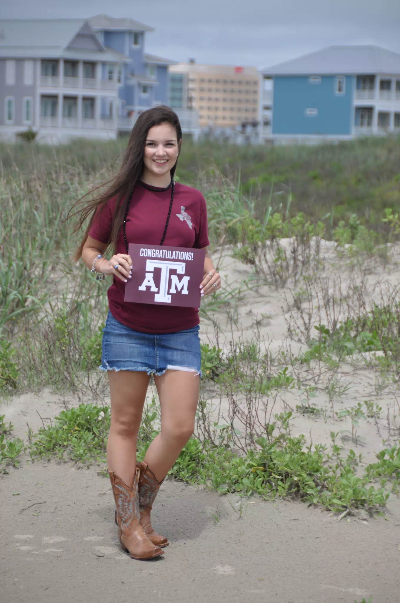 Emily with Texas A&M Sign on Galveston Beach