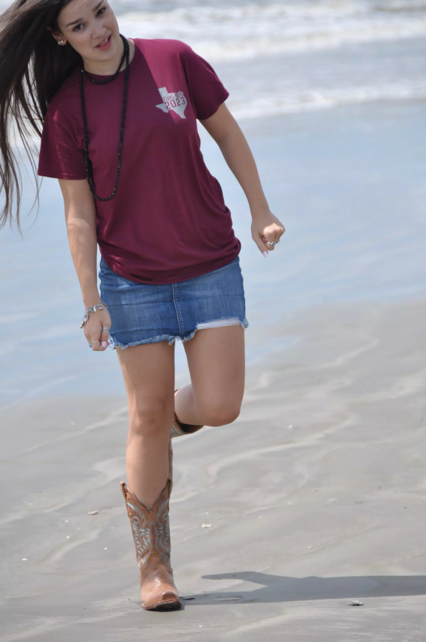 Emily Standing on One Leg on Galveston in Cowgirl Boots