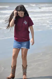 Emily on Galveston Beach in Cowboy Boots and Jean Skirt
