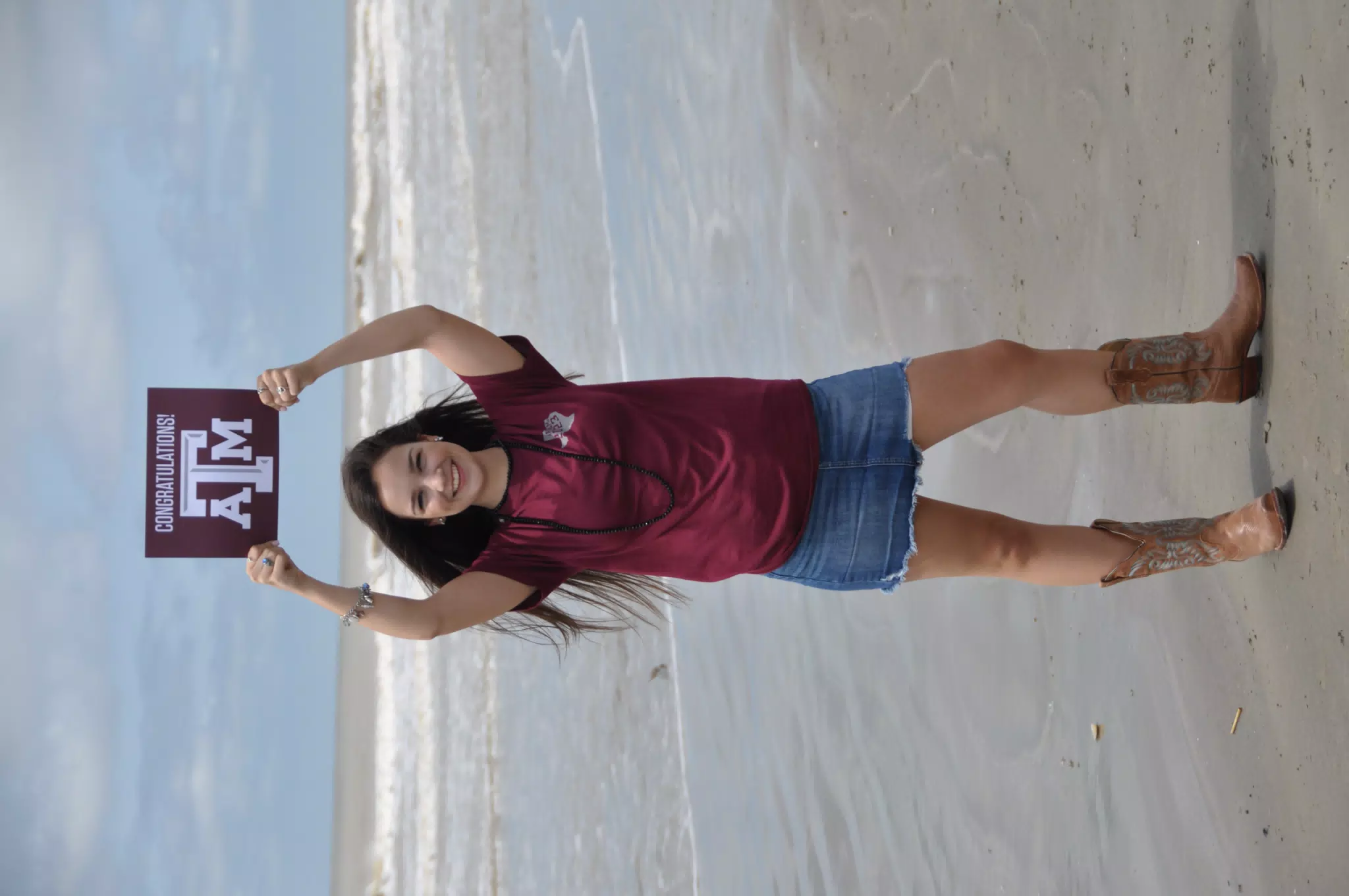Teen Model Holding Texas A&M Aggies Sign on Galveston Beach