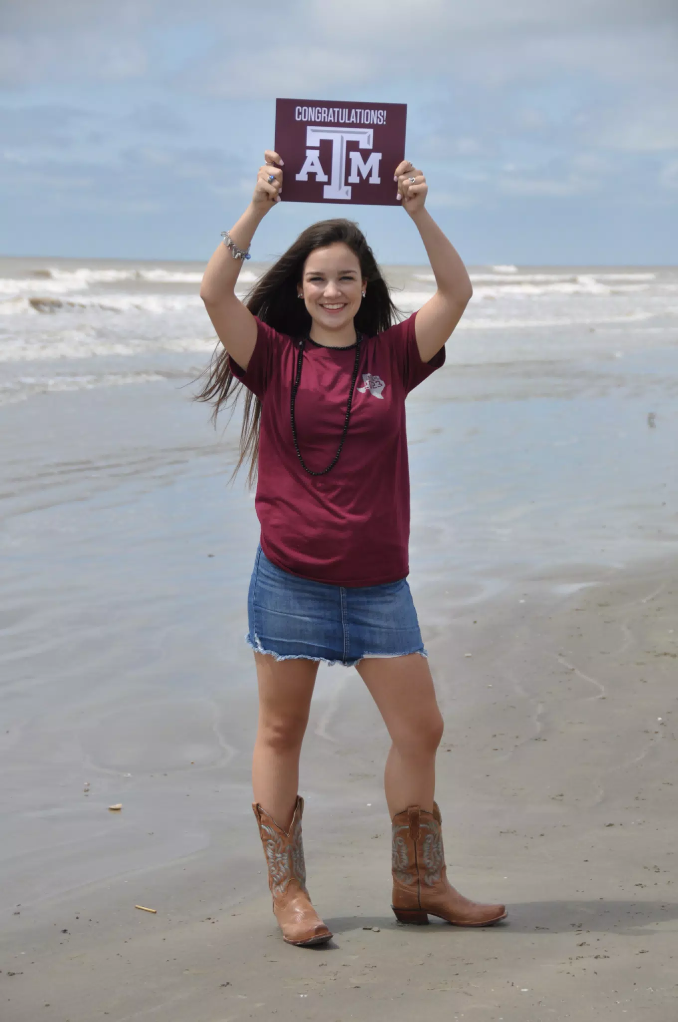 Model with Congratulations Texas A&M Sign on Beach