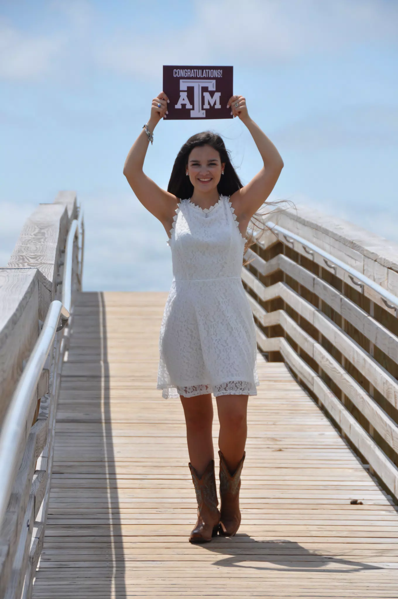 Emily in White Dress with Texas A&M Congrats Sign