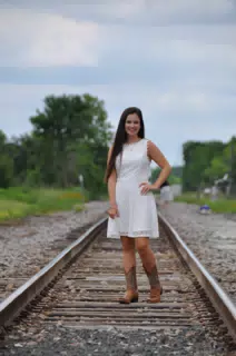Emily on Railroad Tracks in White Dress