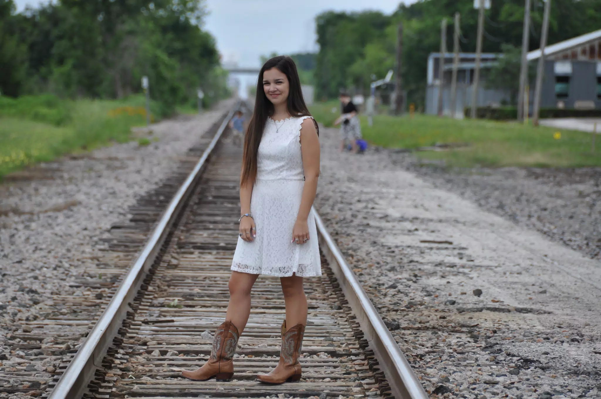 Emily Modeling White Dress and Boots on Railroad Tracks in Galveston Texas