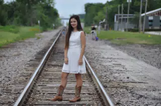 Emily Modeling White Dress and Boots on Railroad Tracks in Galveston Texas