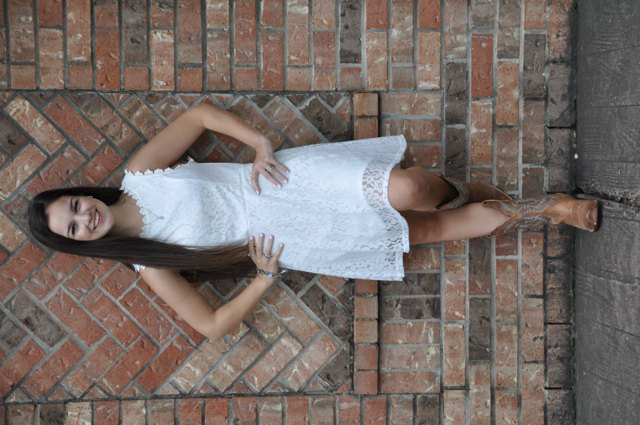 Teen in White Dress Against Brick Wall