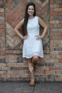 Girl in White Dress on Brick Wall