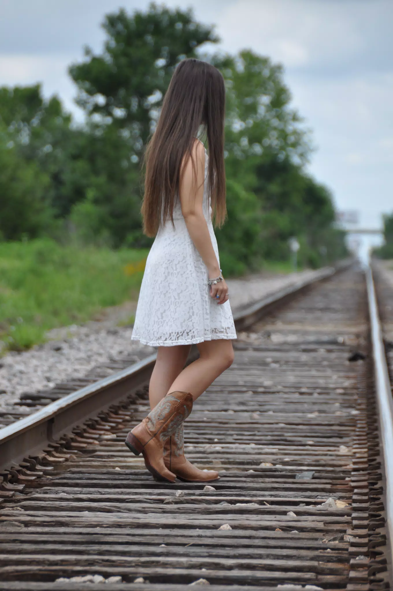 Teen Model in Cowgirl Boots, White Dress on Railroad Tracks