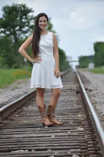 Teen in White Dress and Boots on Railroad Tracks in Texas