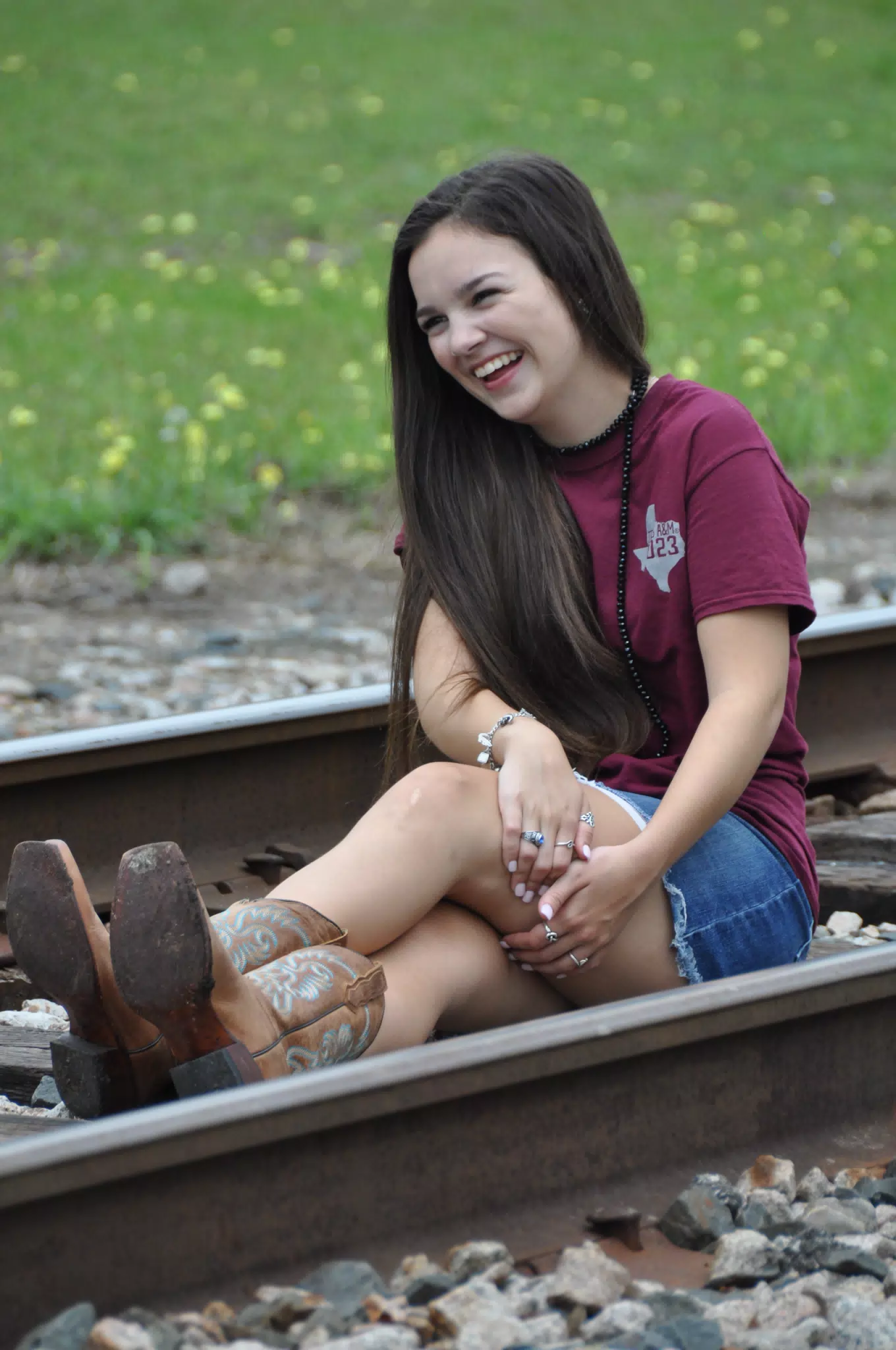 Brunette Model Laughing on Railroad Tracks