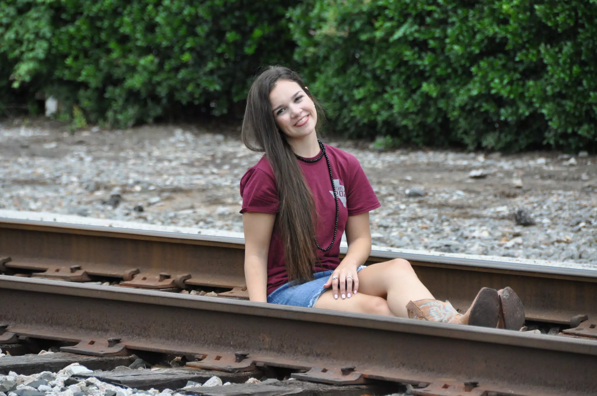 Model with Tongue Out on Railroad Tracks