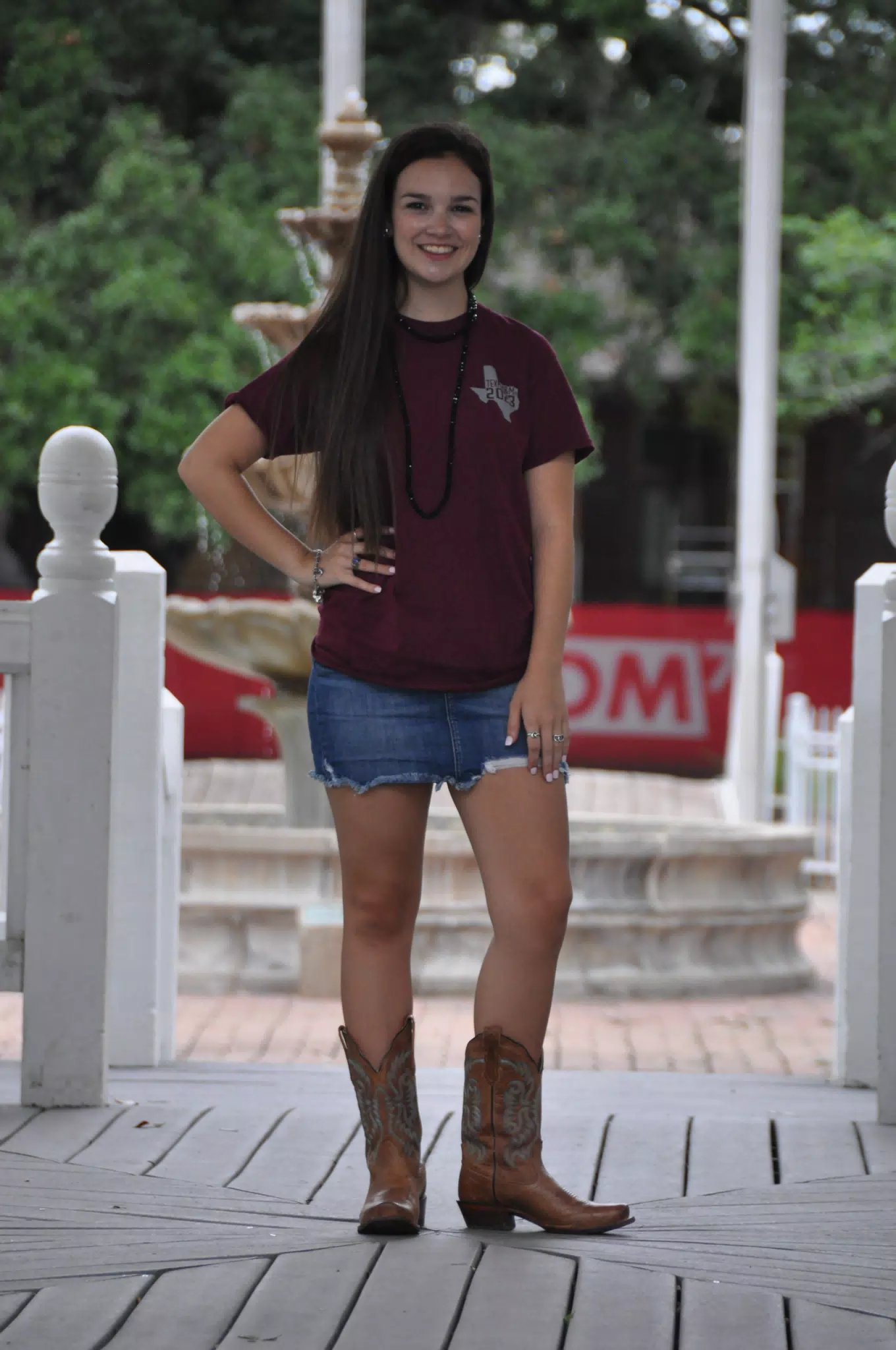 Teen Modeling in Gazebo in Cowgirl Boots and Denim Mini Skirt Brunette
