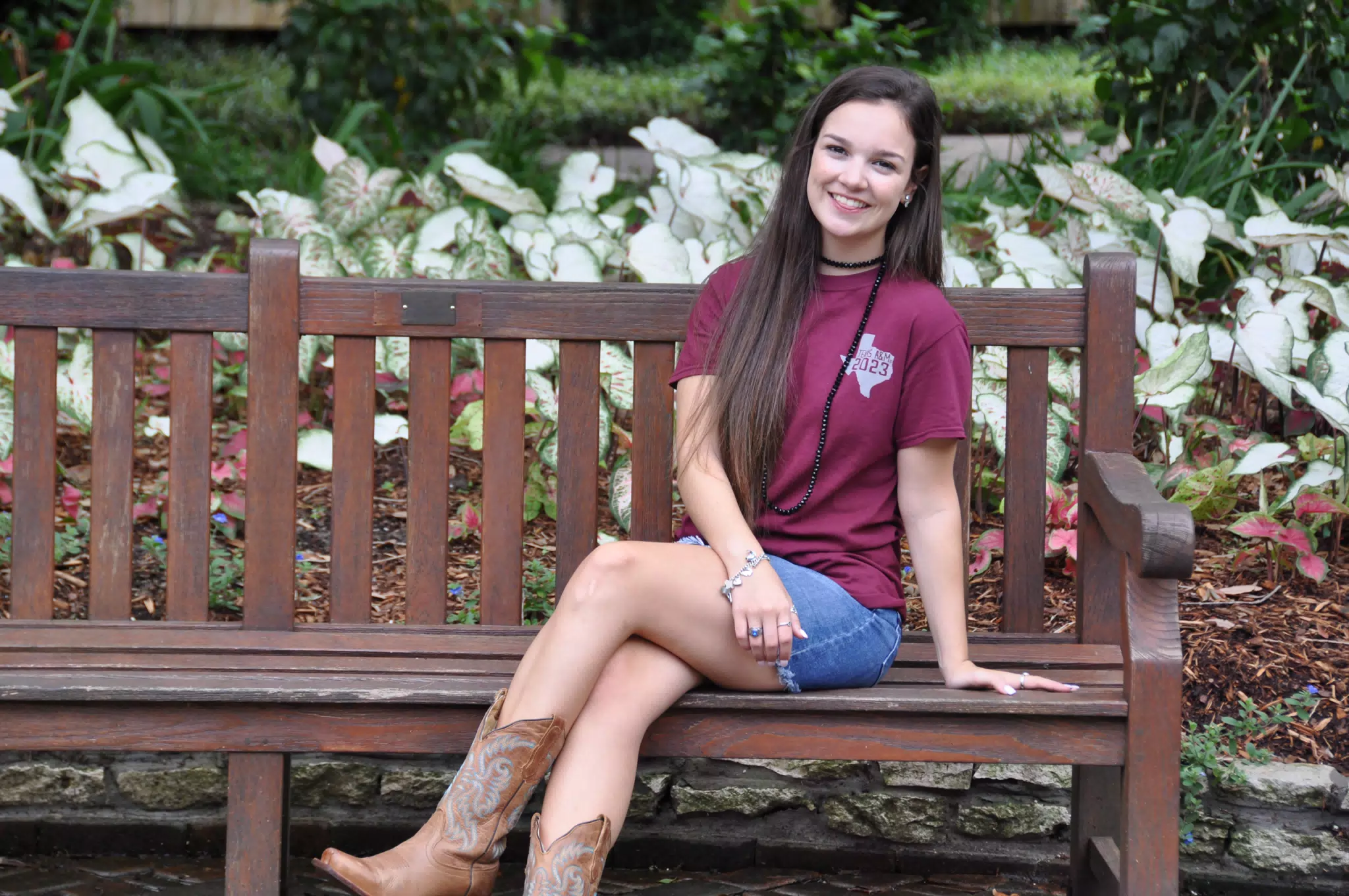 Emily with Tongue Out on Park Bench in Cowgirl Boots