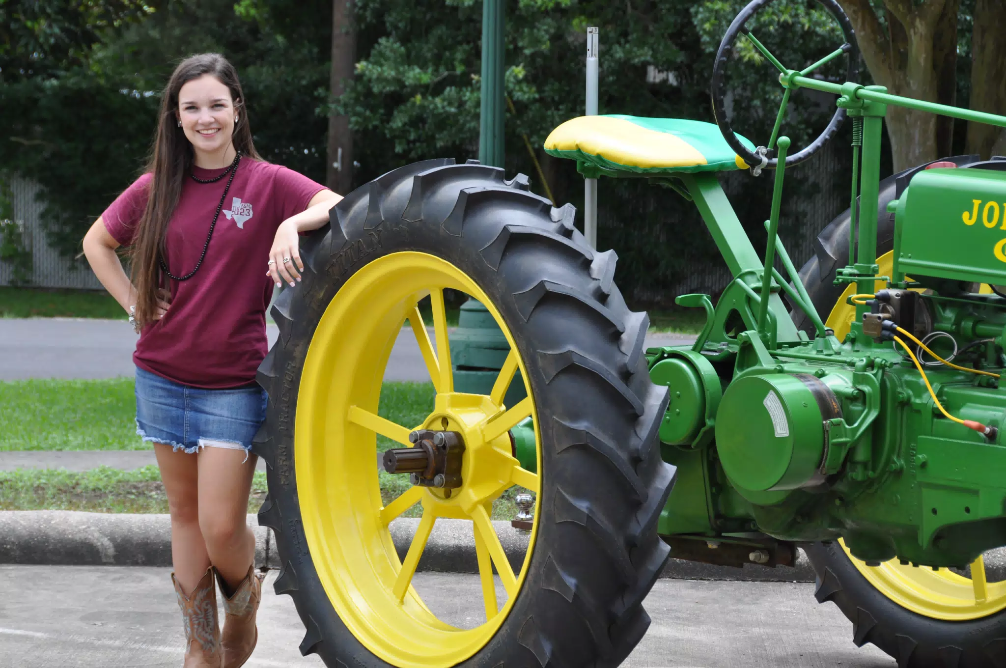 Brunette Teen Model in Jean Miniskirt and Cowboy Boots with John Deere Tractor