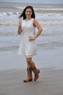Teen in White Dress and Boots on Beach