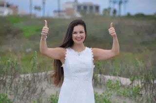 Emily in White Giving Thumbs Up on Galveston Beach