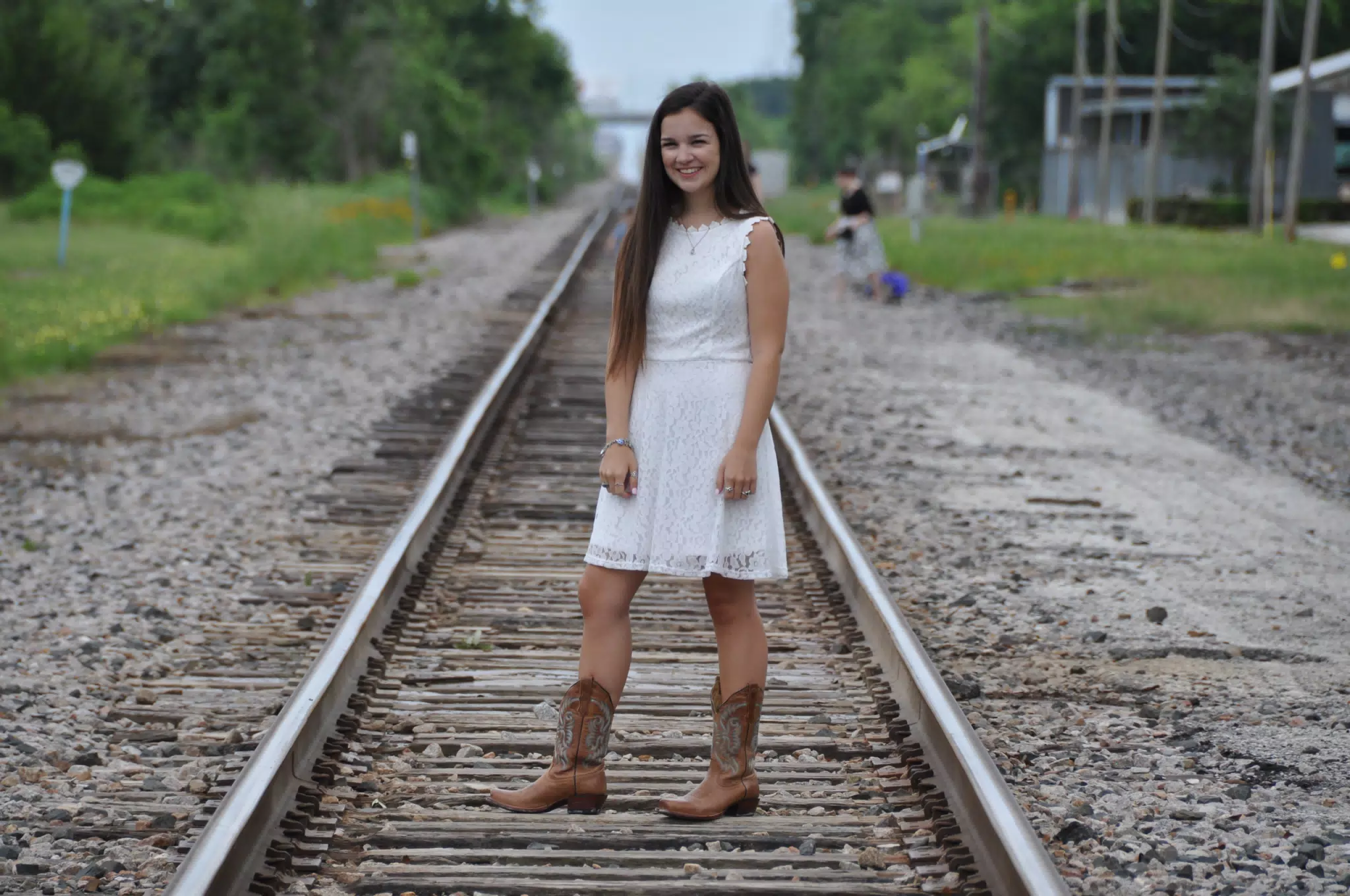 Emily in White Dress on Railroad Tracks