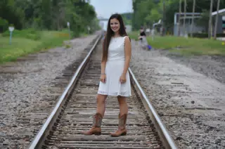 Emily in White Dress on Railroad Tracks