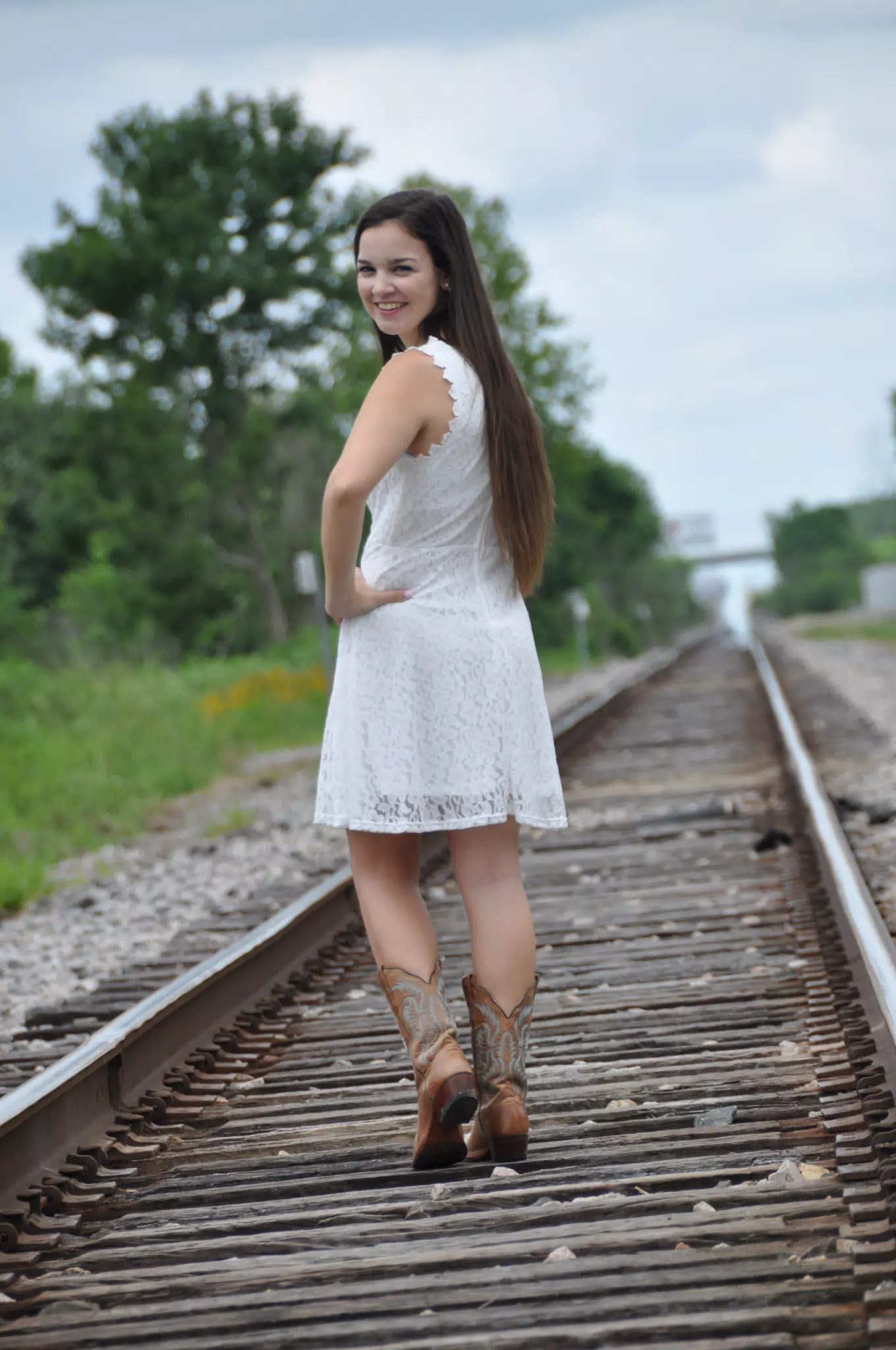 Emily Walking on Railroad Tracks in Texas in Boots