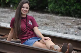 Brunette Model in Miniskirt and Boots on Railroad Tracks