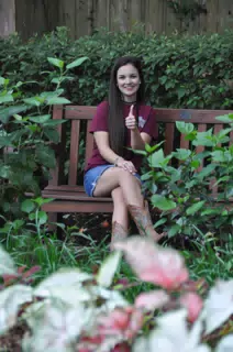 Emily Thumbs Up Posing on Park Bench