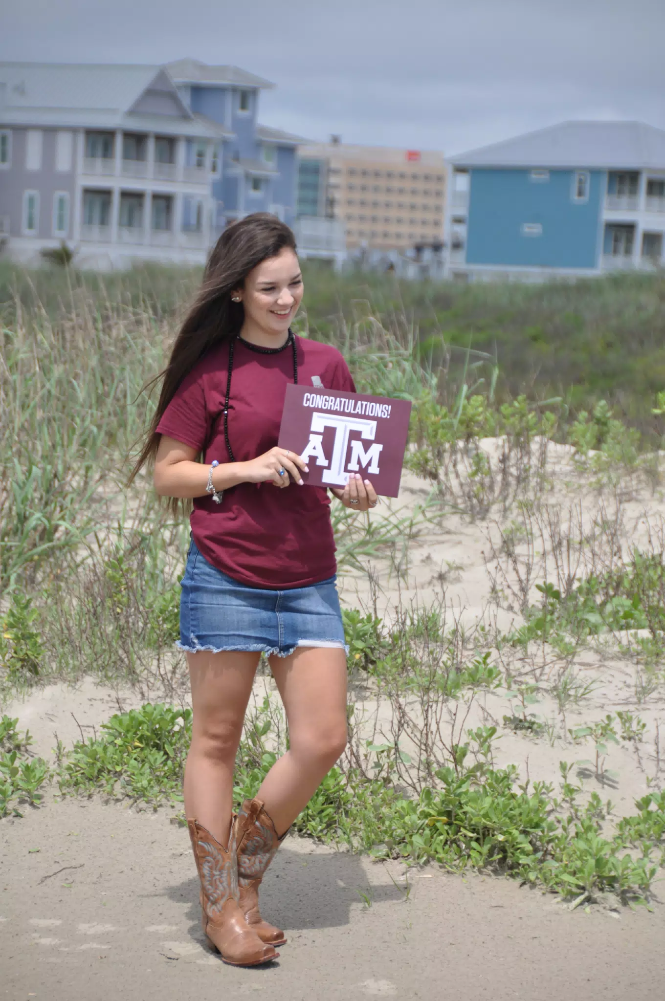 Emily in Jean Skirt with Aggies Sign on Galveston Beach