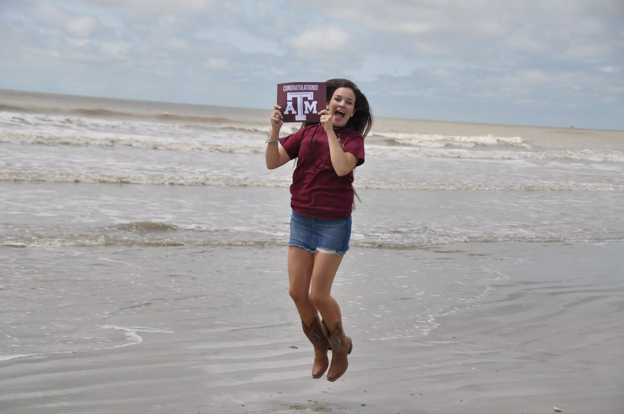 Teen Jumping with Texas A&M Sign