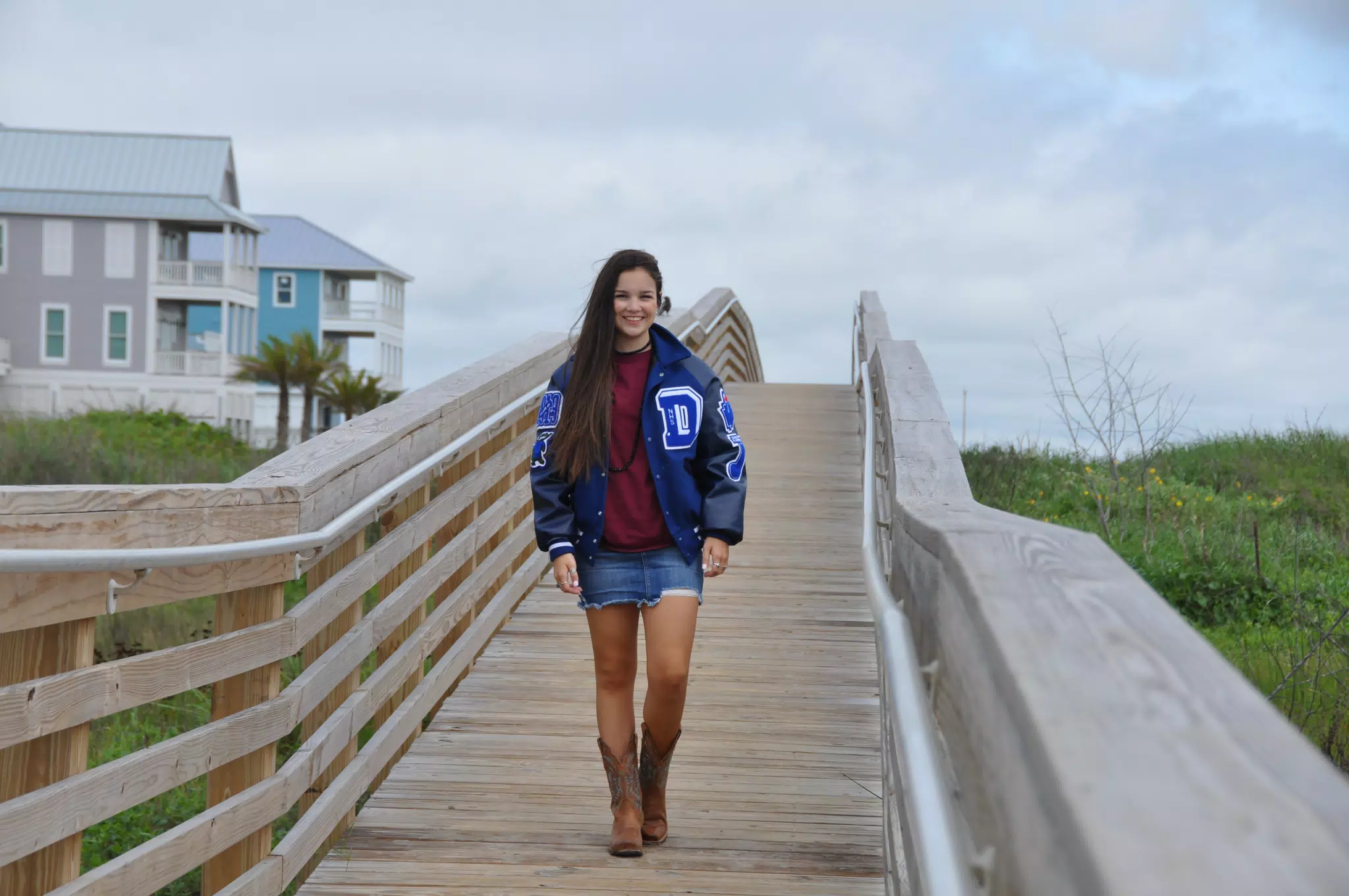 Teen in Letterman Jacket on Galveston Boardwalk
